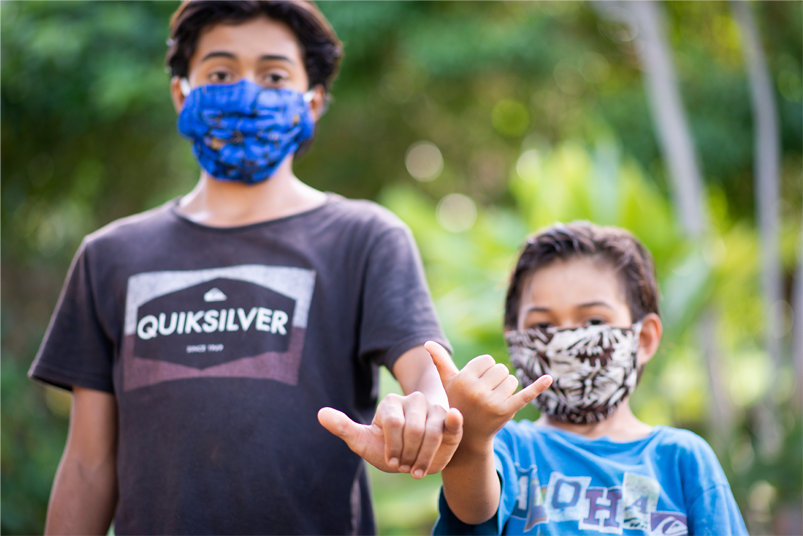 Two young boys wearing masks