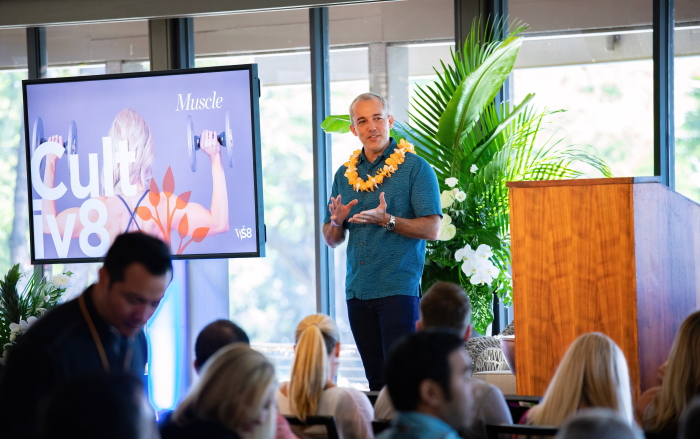 Matt Beall giving a presentation while wearing a lei