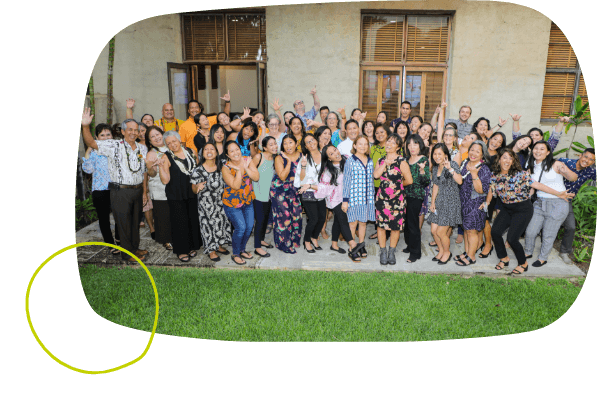 The Hawaii Community Foundation team all standing together while smiling and waving happily at the camera.