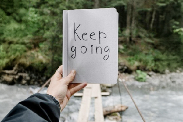 A woman holding a calculator doing financial planning